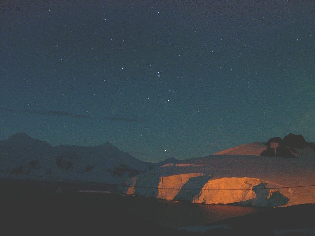 Light pollution illuminating the ice
cliffs with Orion setting behind